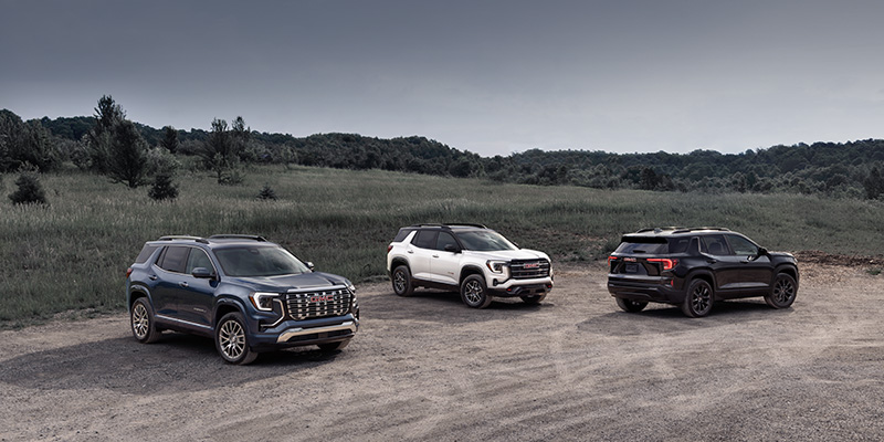 Three 2026 GMC Terrain models parked in a dirt field highlighting affordable maintenance in St. Clairsville, OH